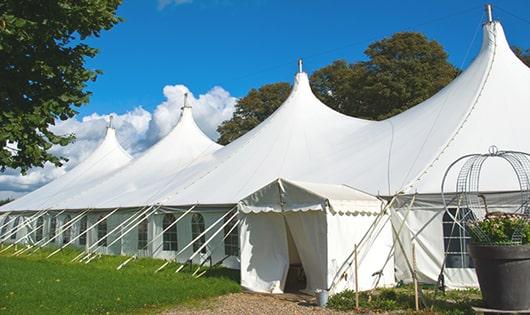 tall green portable restrooms assembled at a music festival, contributing to an organized and sanitary environment for guests in Florham Park, NJ